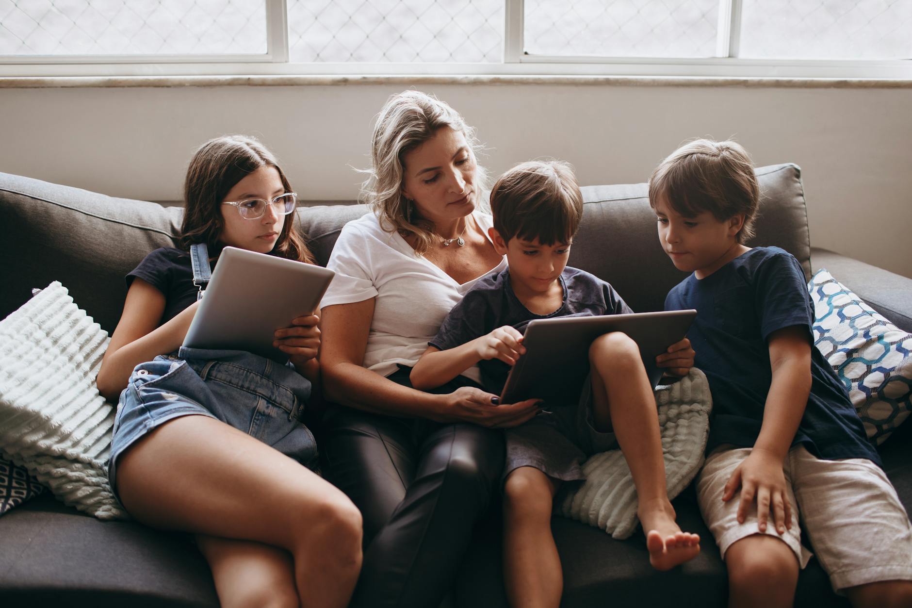 mother sitting with children on couch
