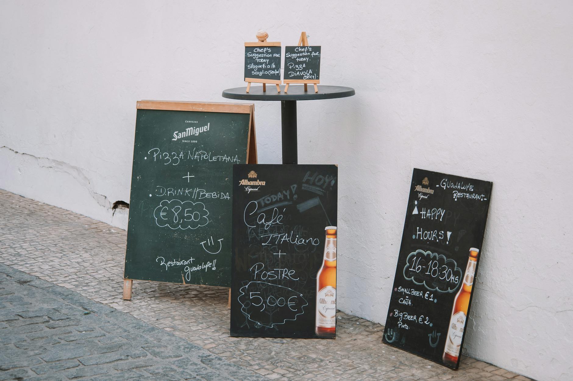 advertisements on chalk board near wall