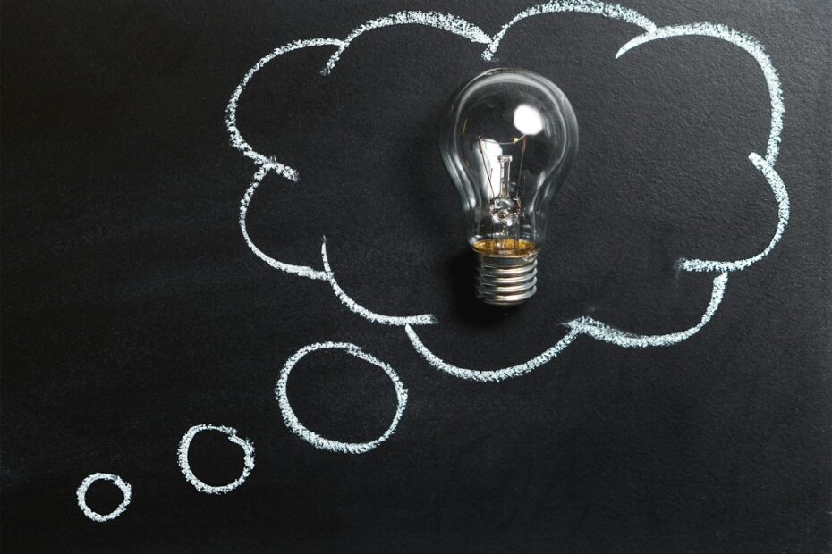 clear light bulb placed on chalkboard