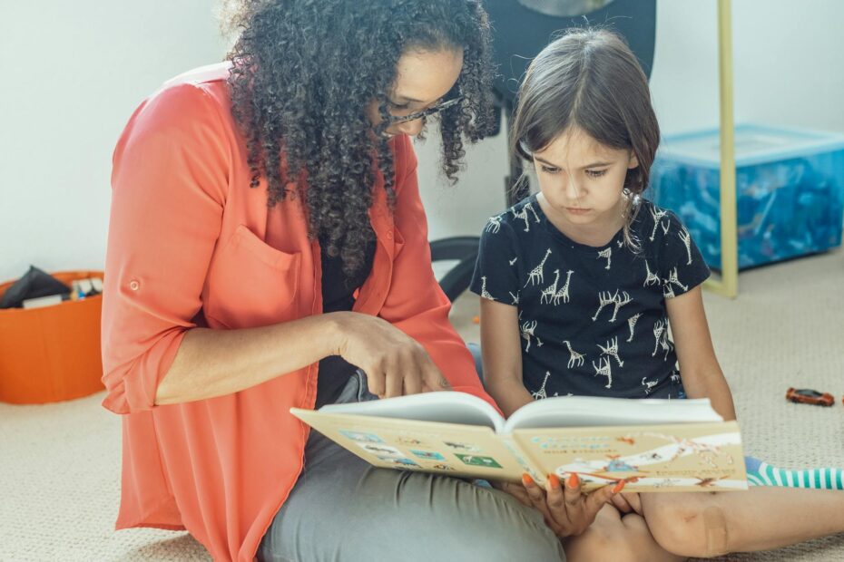 a woman and a gril reading a book