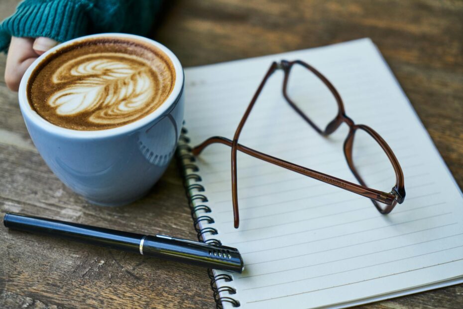 brown eyeglasses on white notebook